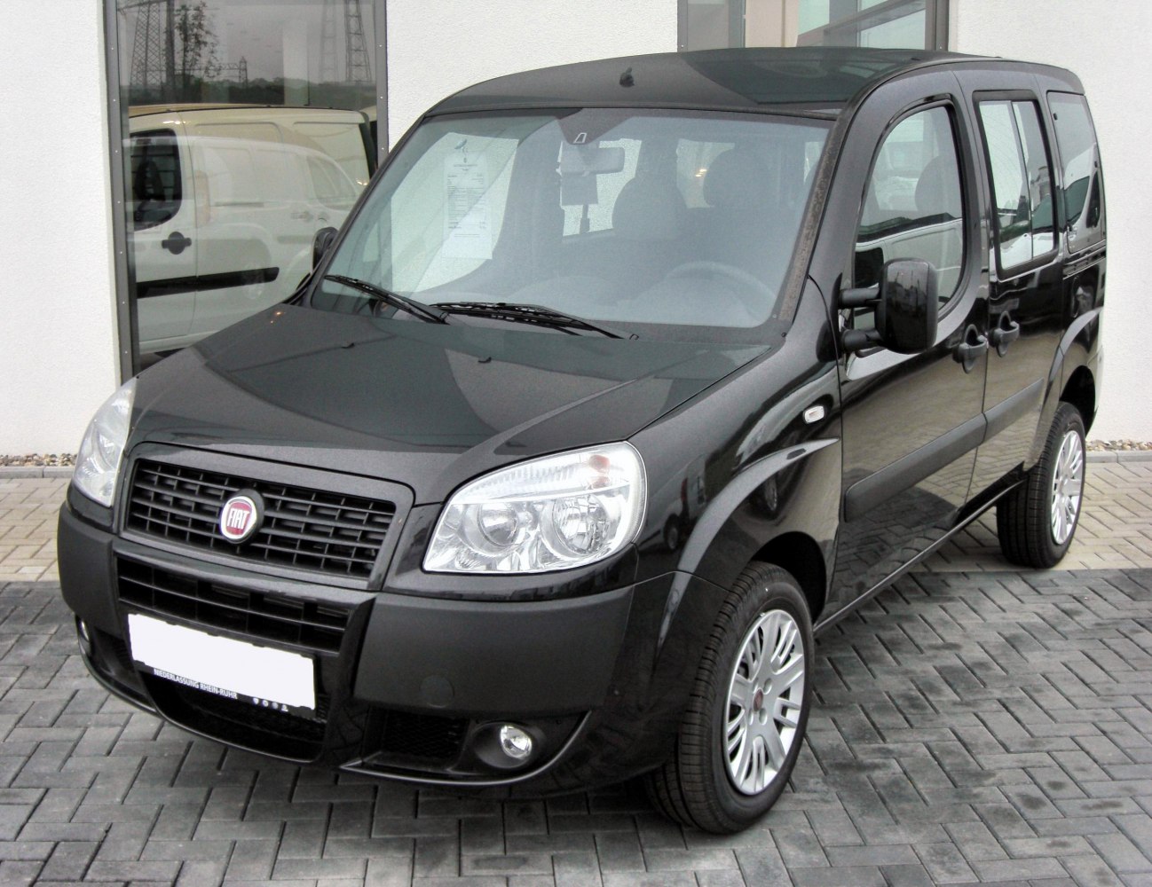Front and side view of compact multi-purpose vehicle with distinct grille and headlight design