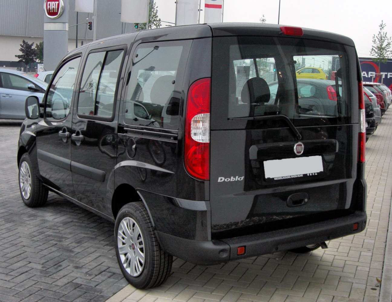 Rear view of a compact van with distinctive taillights and rear window wiper