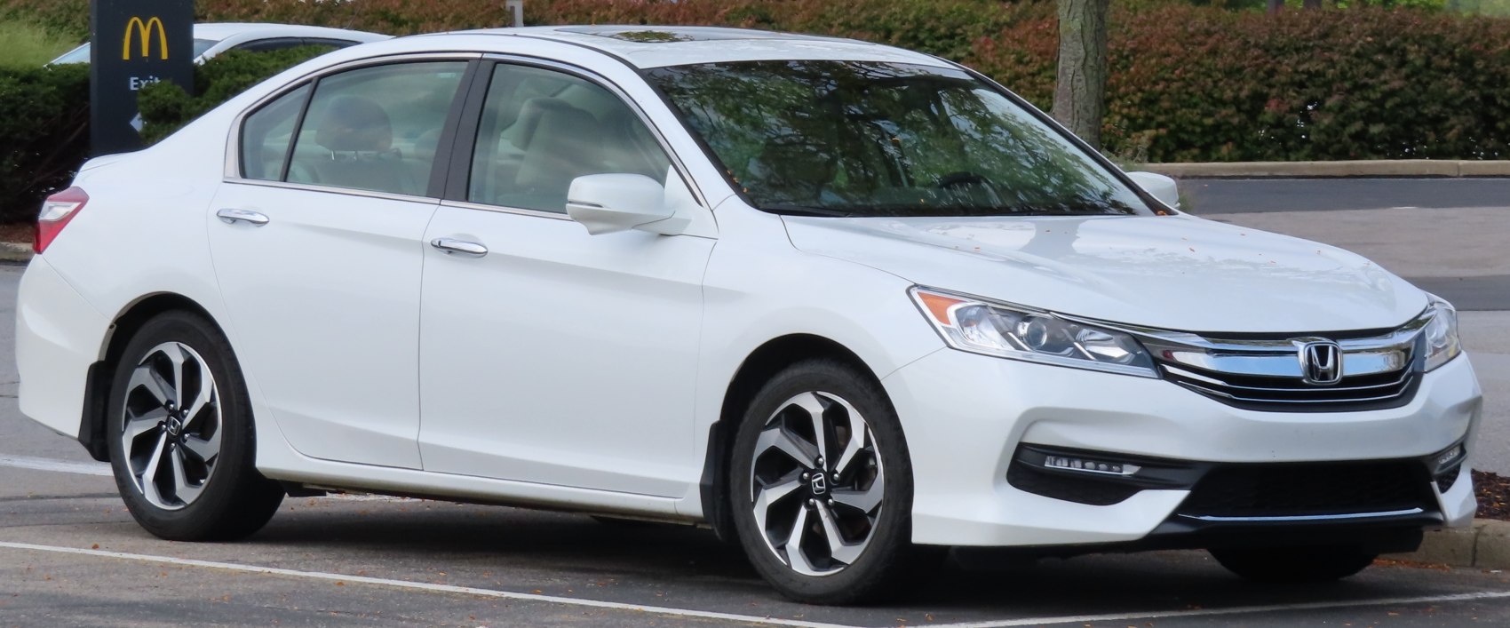 Side-front view of a sleek sedan with alloy wheels and modern headlights