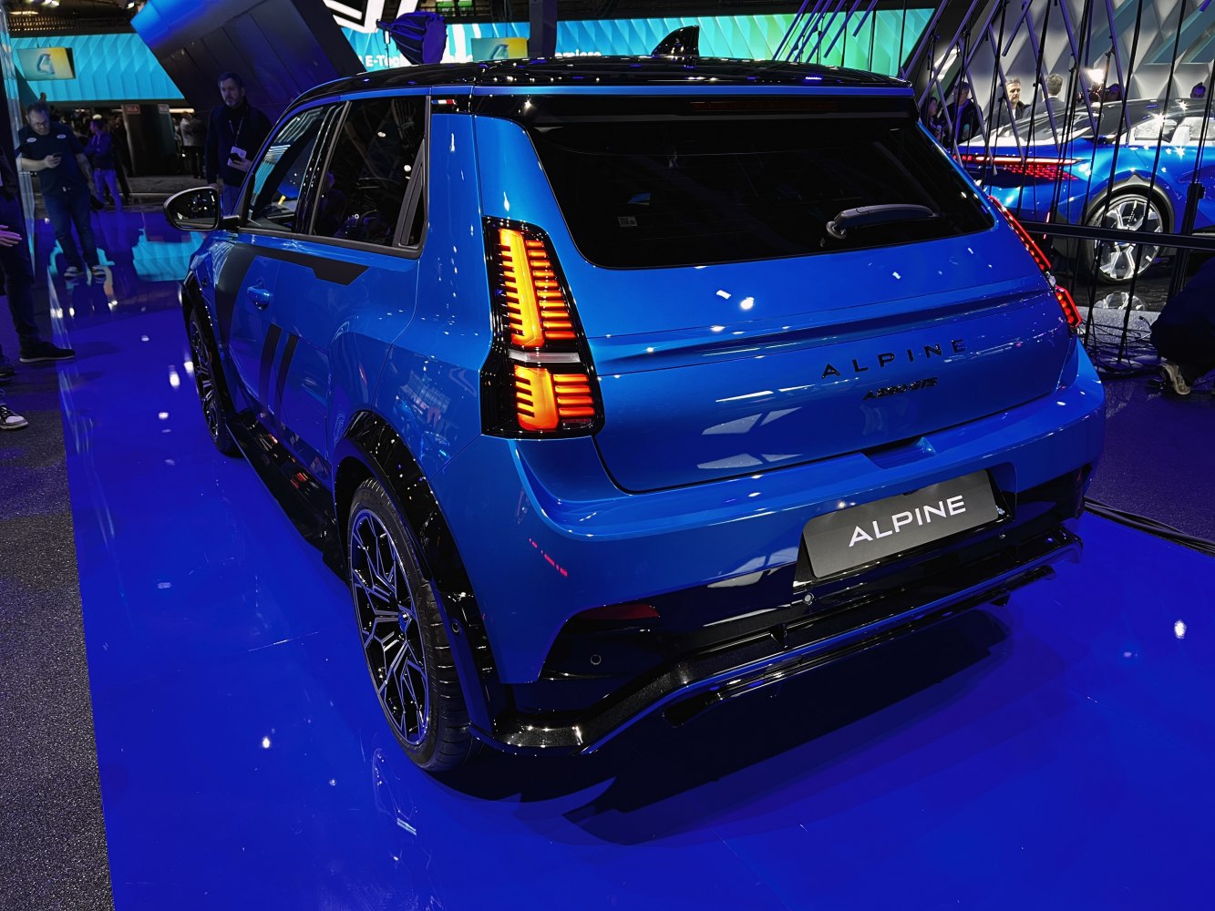 Blue car rear with distinctive taillights and sporty side profile