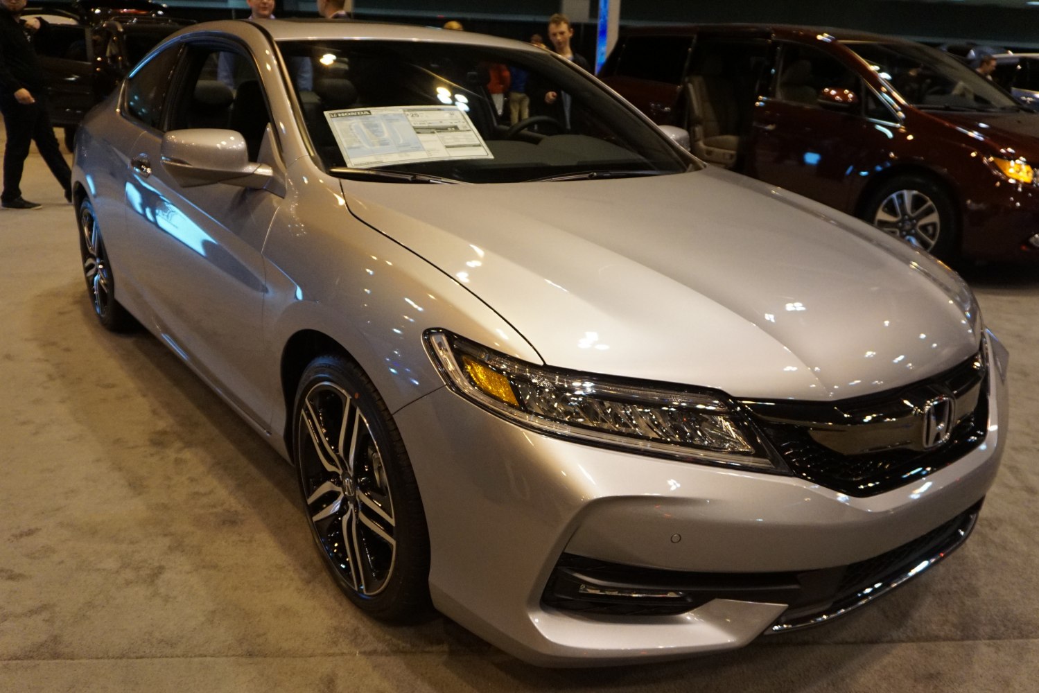 Front left angle of a silver coupe with LED headlights and alloy wheels