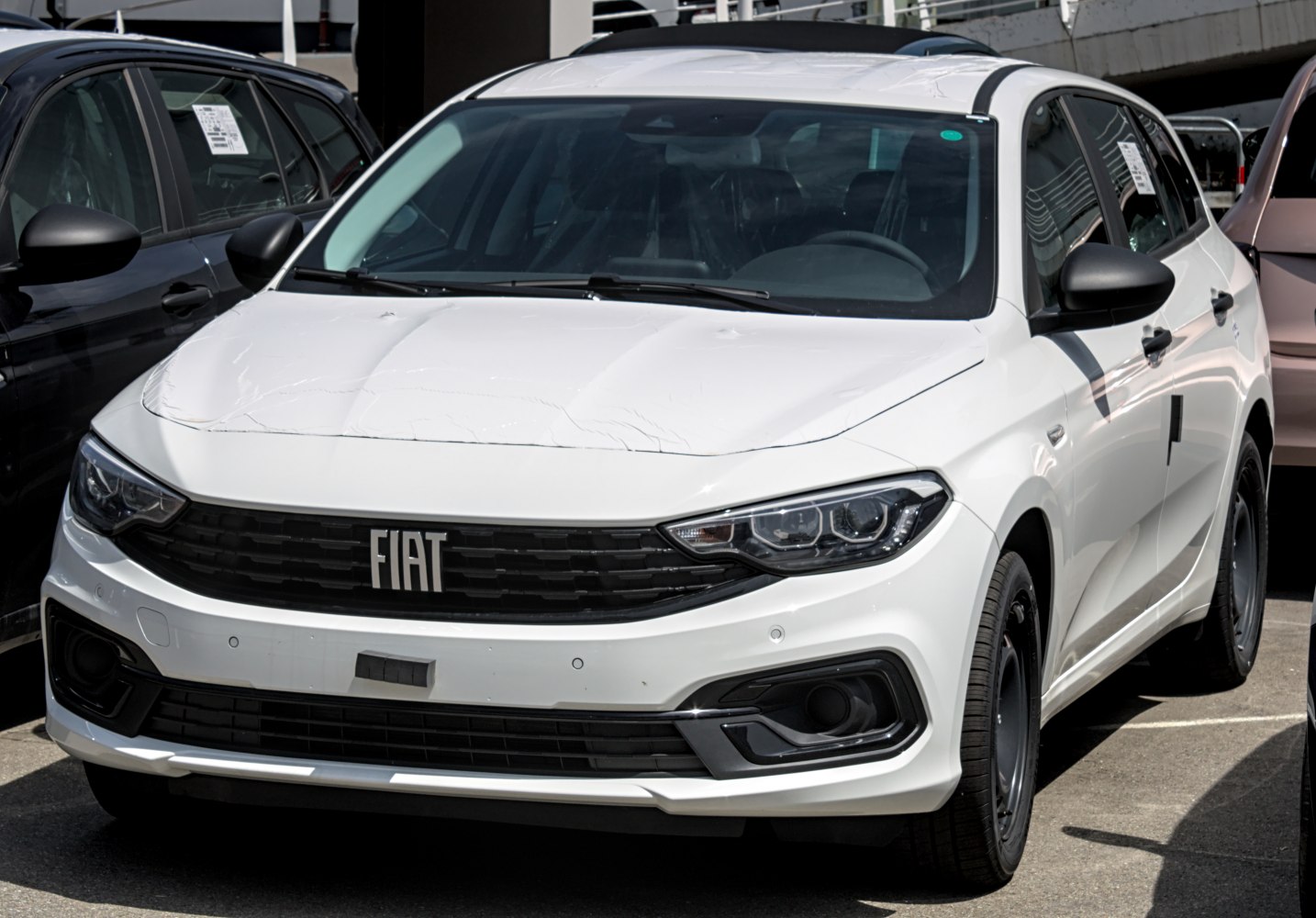 Front view of a white compact wagon with modern headlights and grille