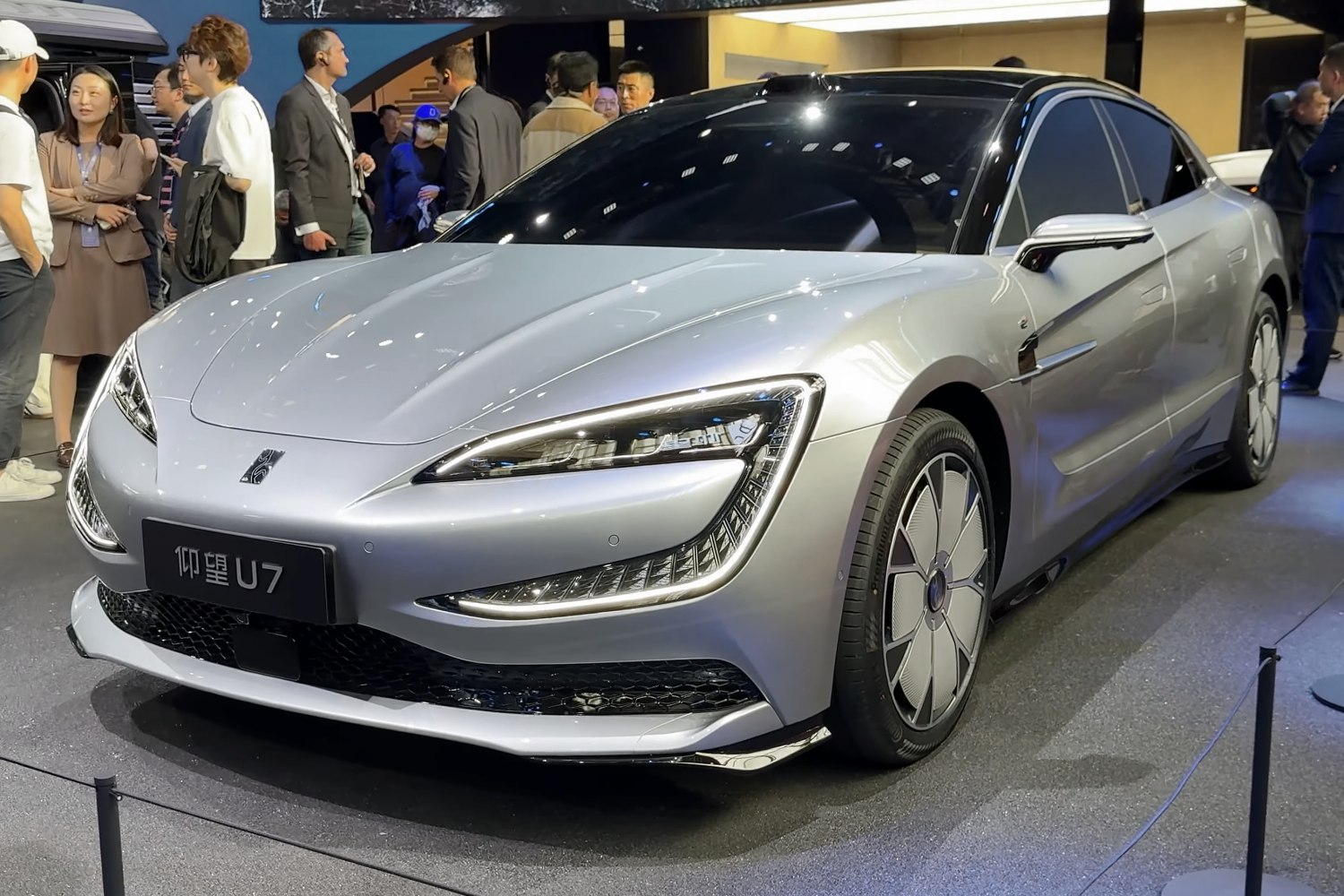 Aerodynamic front with futuristic LED headlights and unique wheel covers.