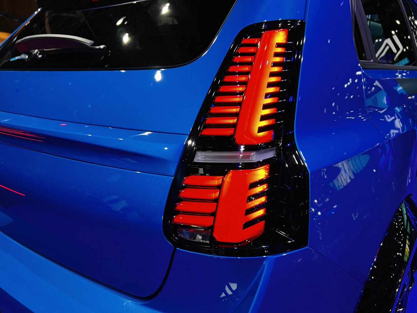 Close-up of modern rear taillight and blue rear panel