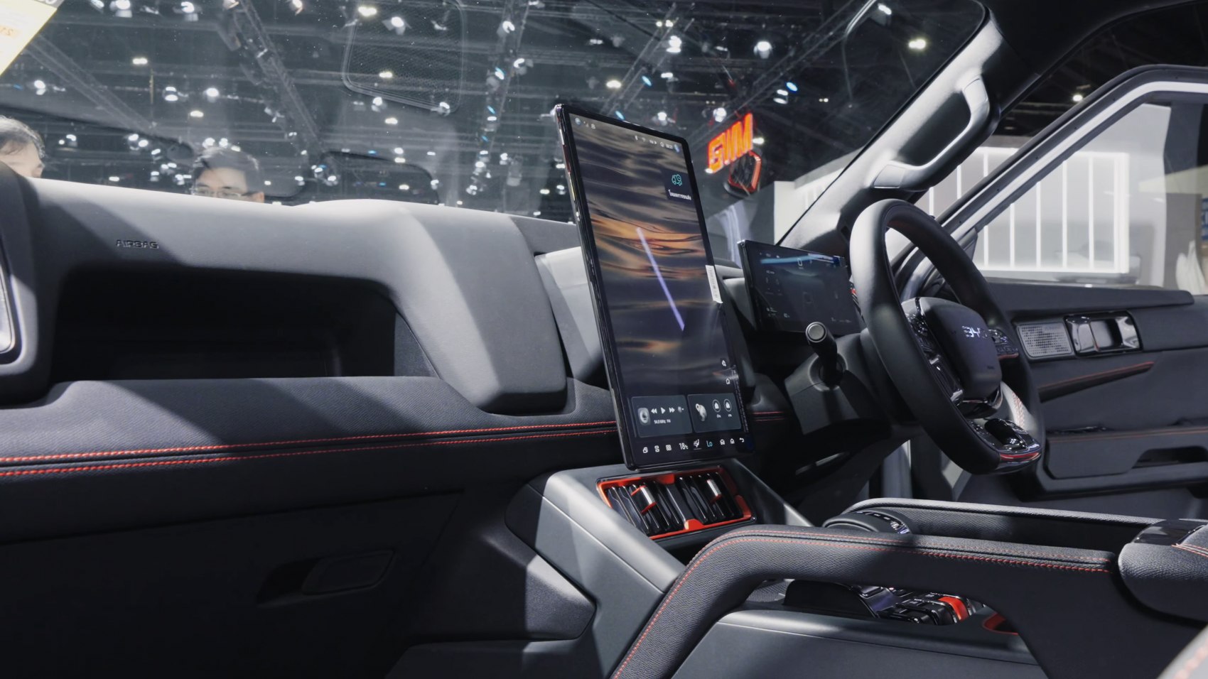 Vertical touchscreen and modern dashboard with red stitching