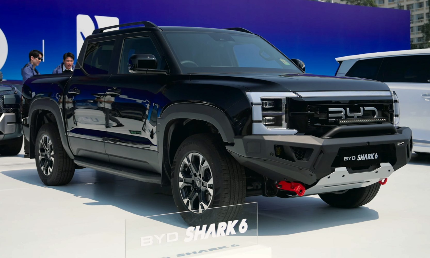 Black pickup truck front side with bold grille and off-road tires