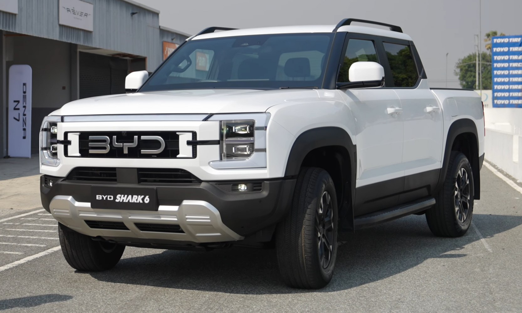 Front and side view of electric pickup with LED headlights and rugged design