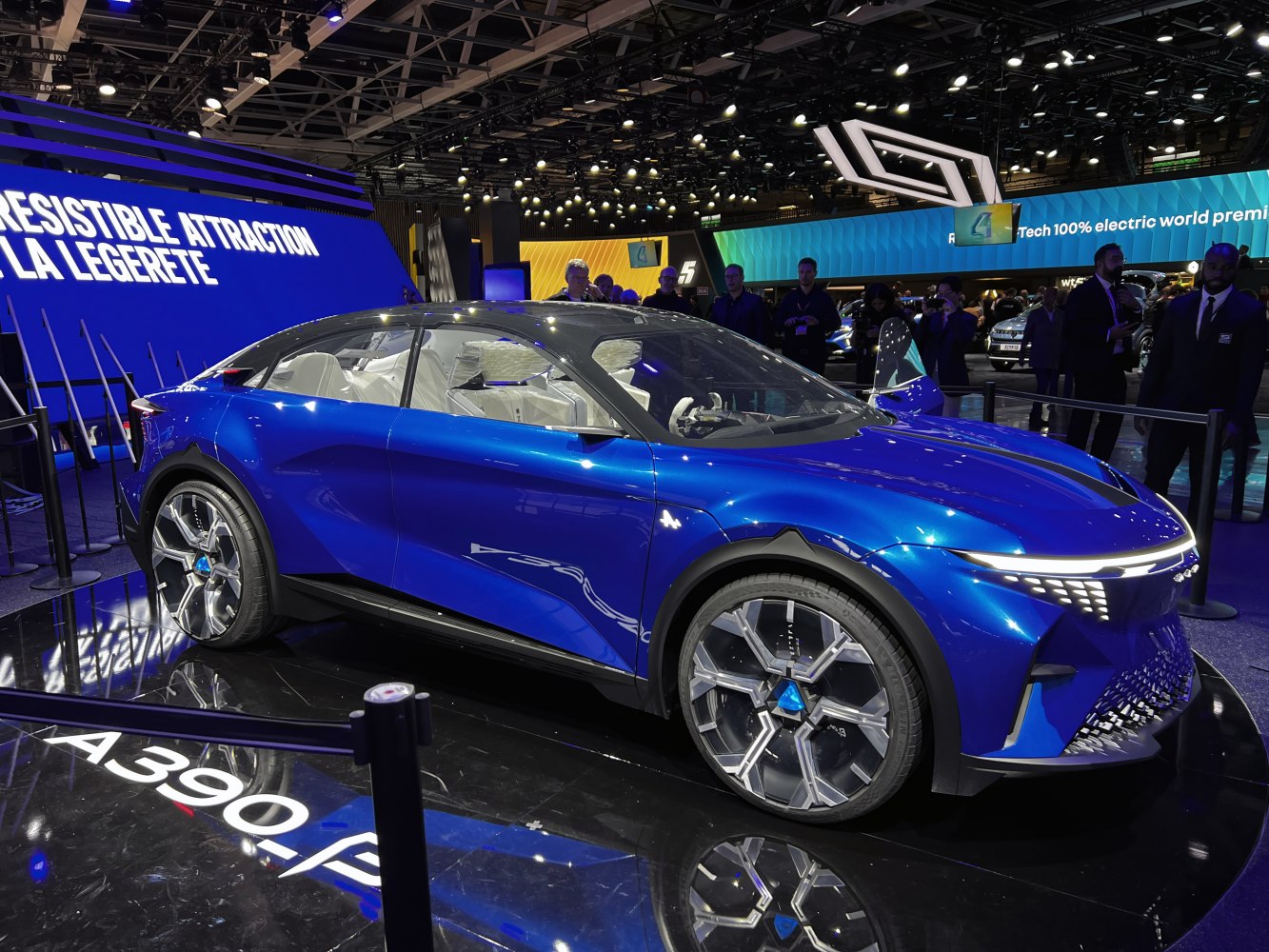 Futuristic blue electric SUV with LED headlights and aerodynamic design.