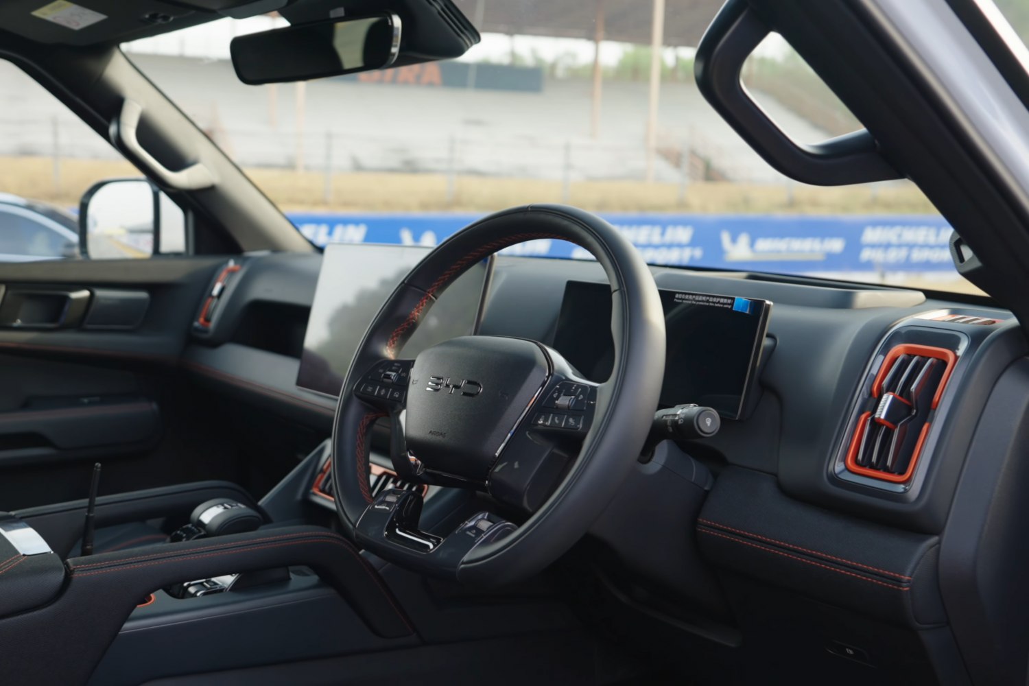 Steering wheel with controls and dual touchscreen dashboard