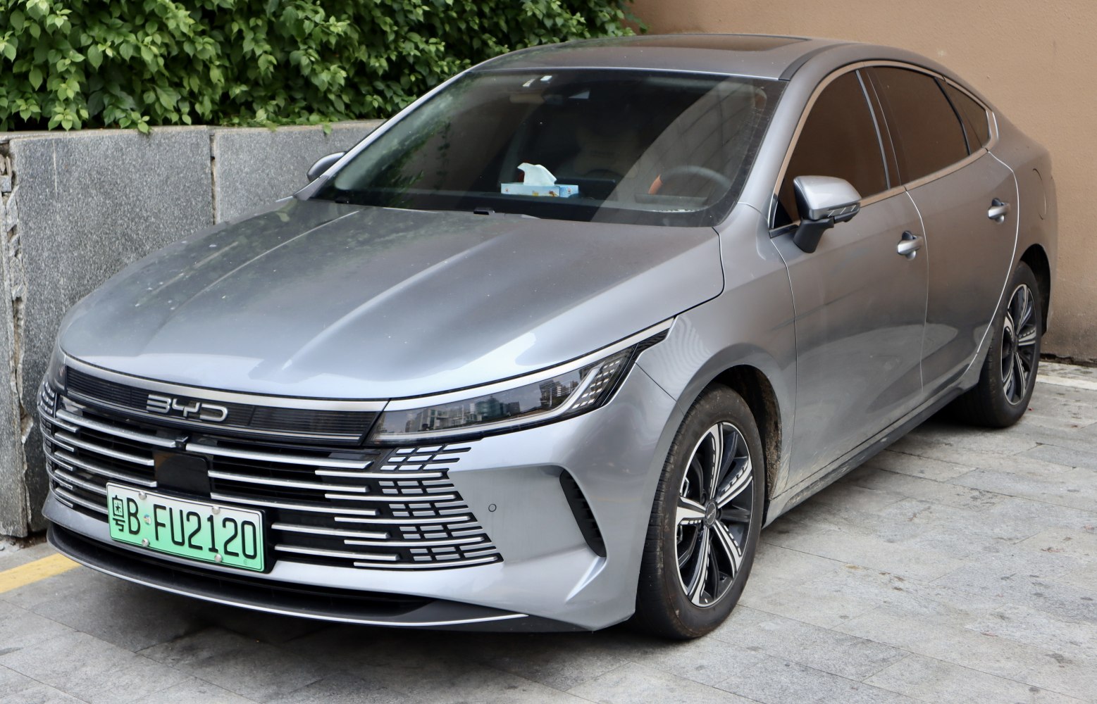 Sleek front grille and sharp headlights with alloy wheels on a sedan.