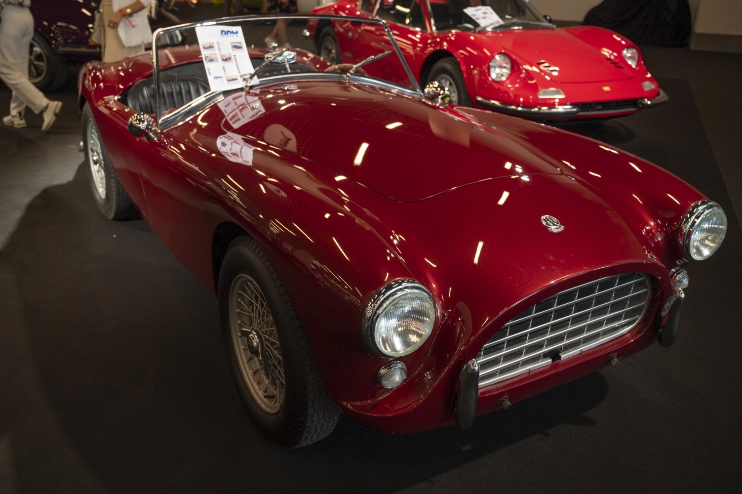 Red vintage roadster with wire spoke wheels and chrome grille