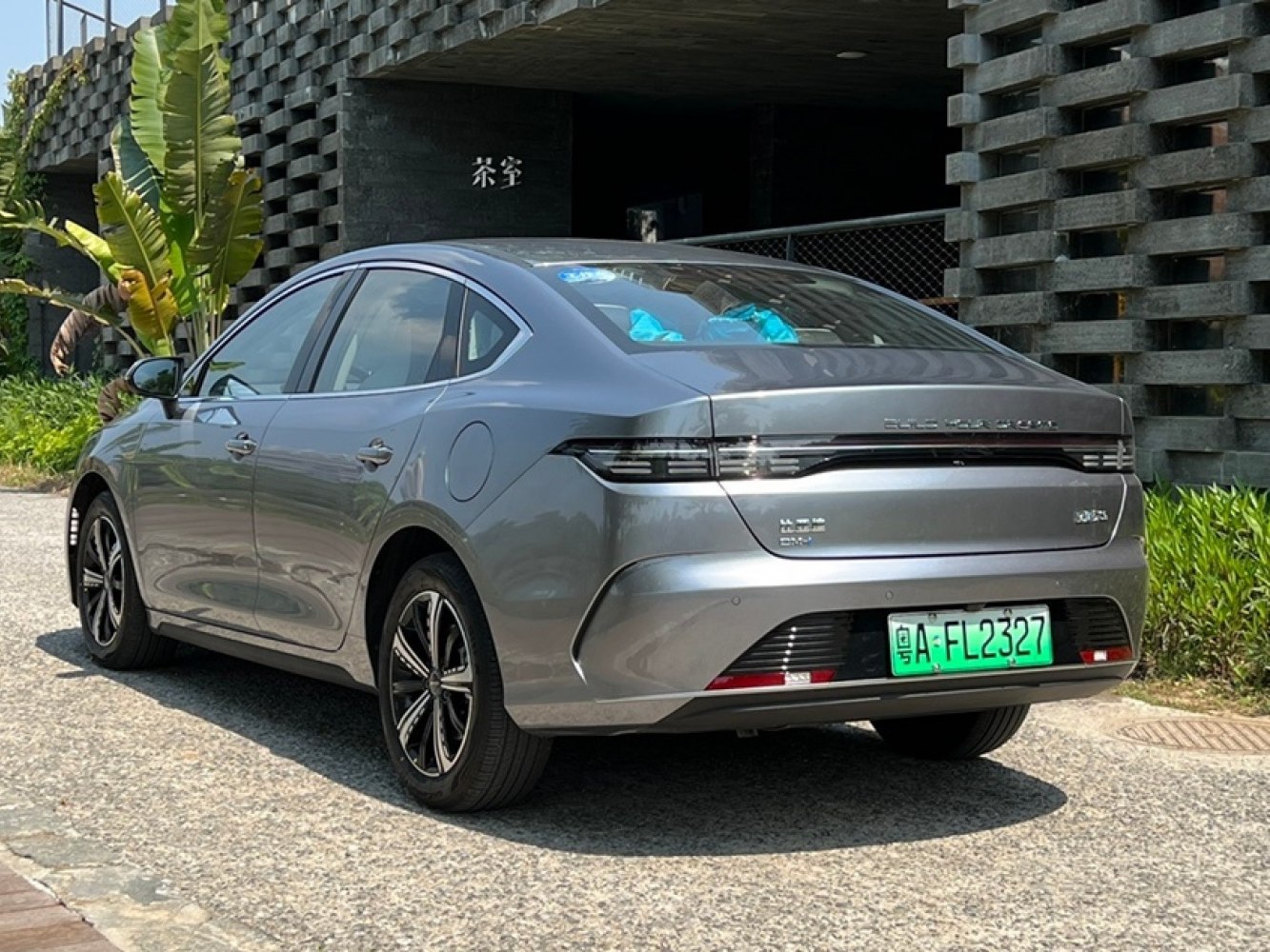 Rear and side profile of a silver 2022 sedan with sleek, futuristic taillights.