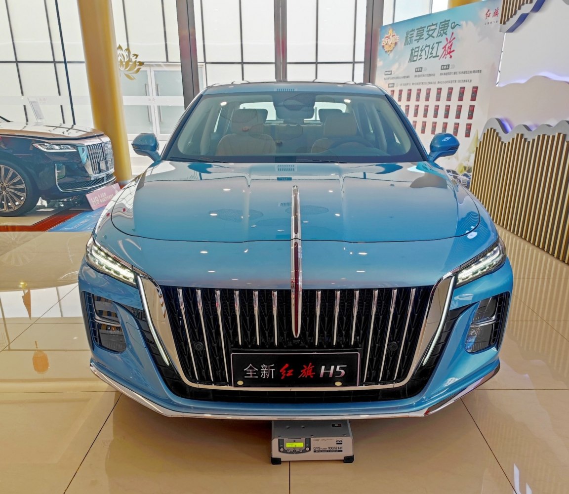 Front view with vertical chrome grille and sleek headlights