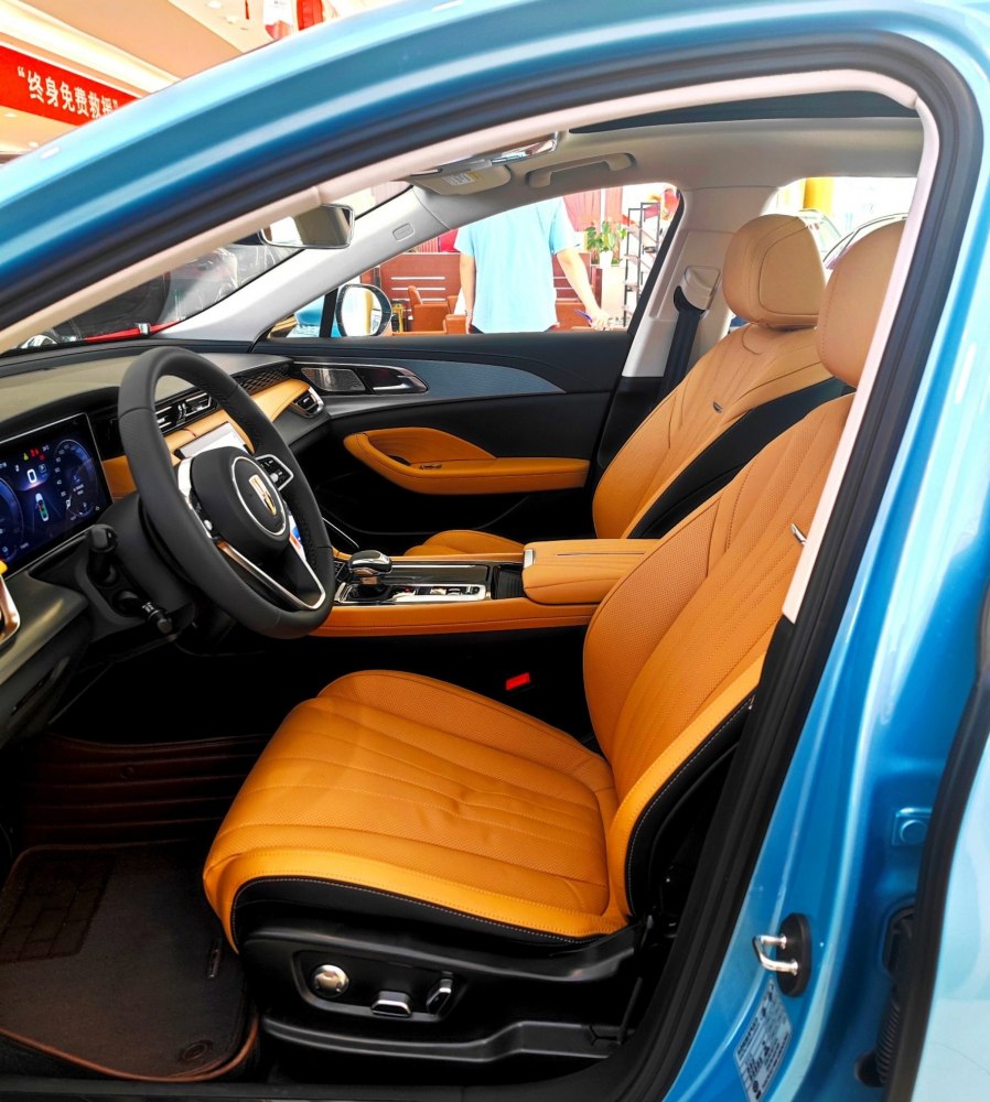 Tan leather seats and modern cockpit interior design