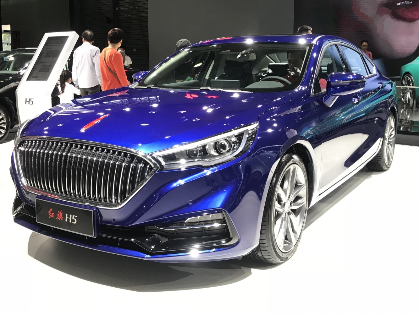 Sleek modern sedan with vertical-slat grille and LED headlights
