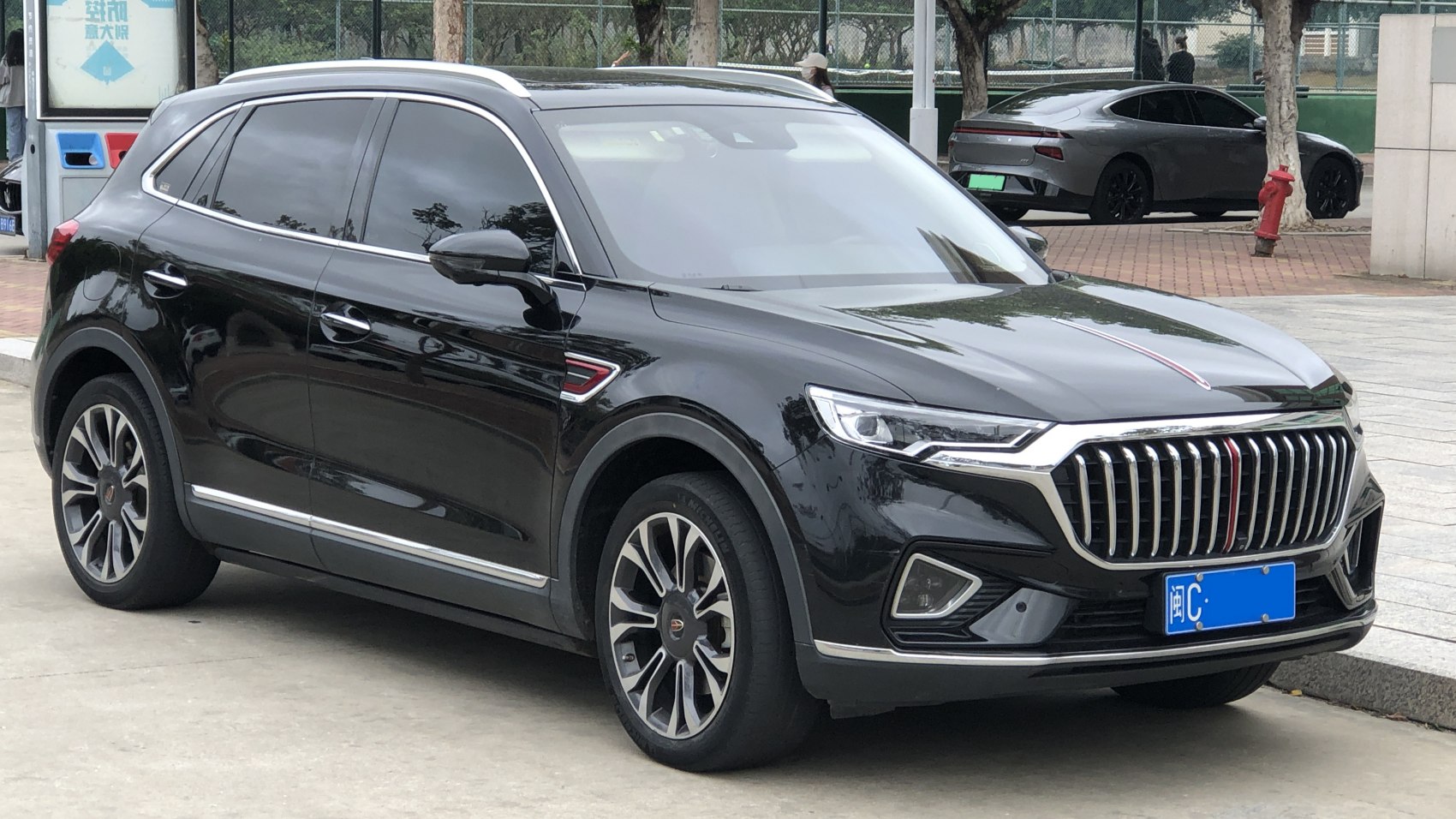 Luxury SUV with vertical slat grille and sharp LED headlights.
