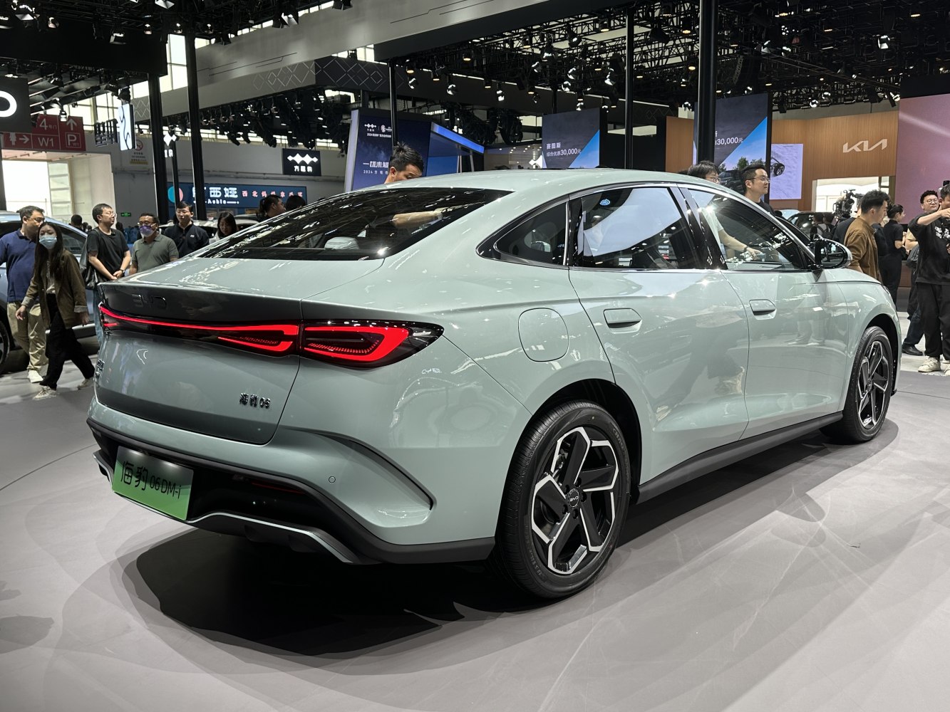 Sleek electric sedan rear design with distinctive alloy wheels