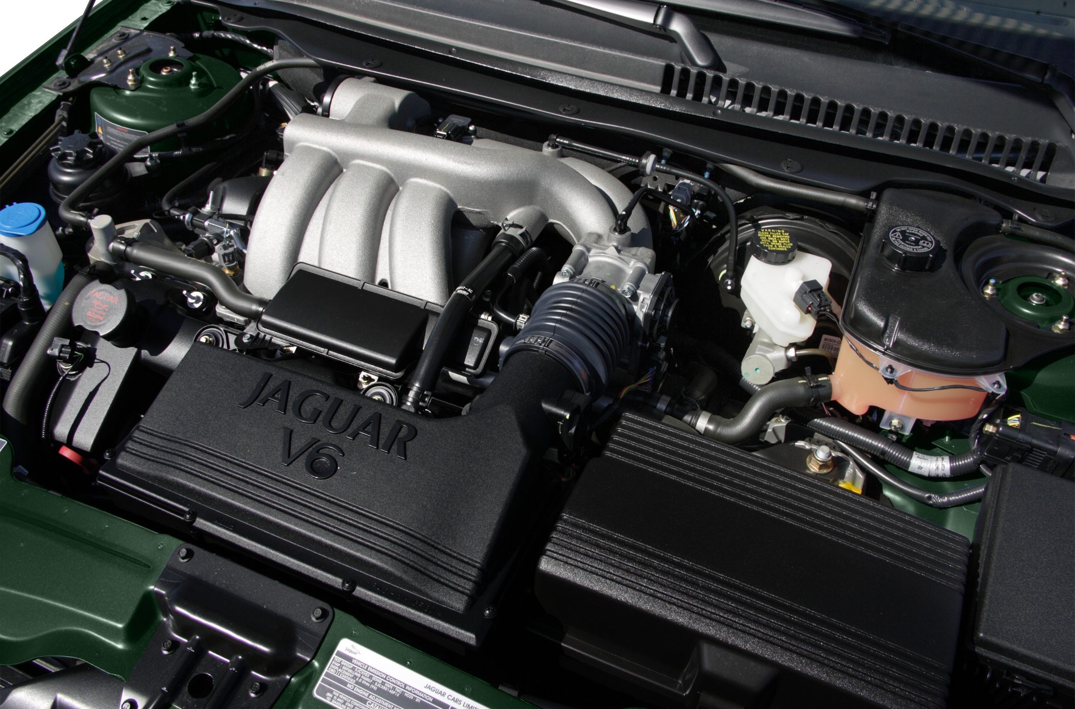 Jaguar V6 engine with intake manifold and fluid reservoirs