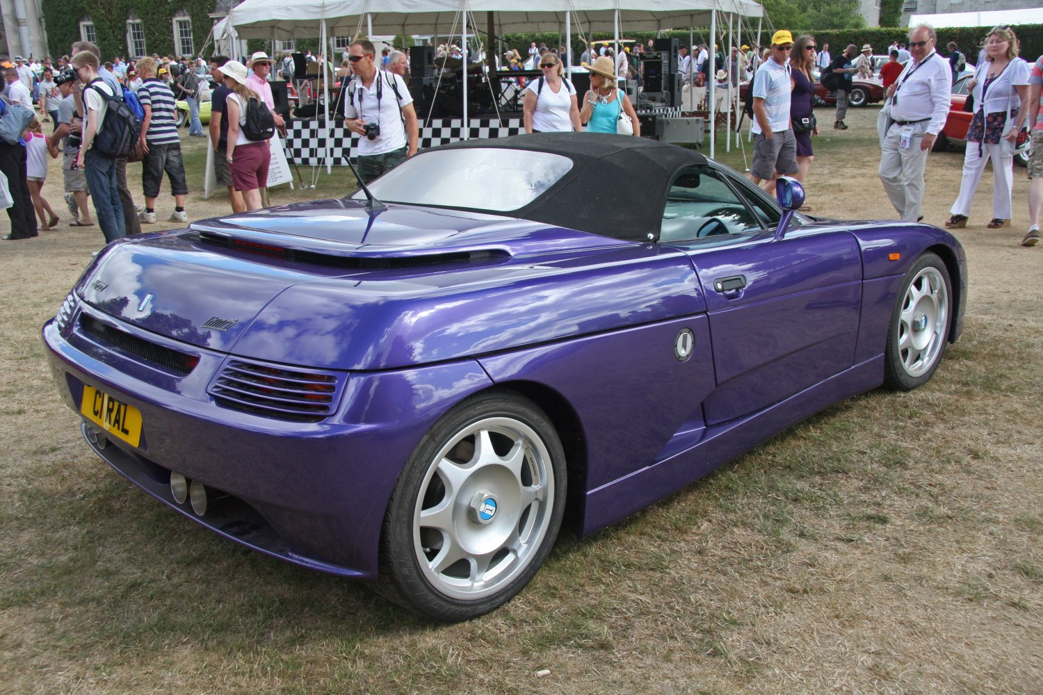 Rear view of purple convertible with dual exhaust and alloy wheels