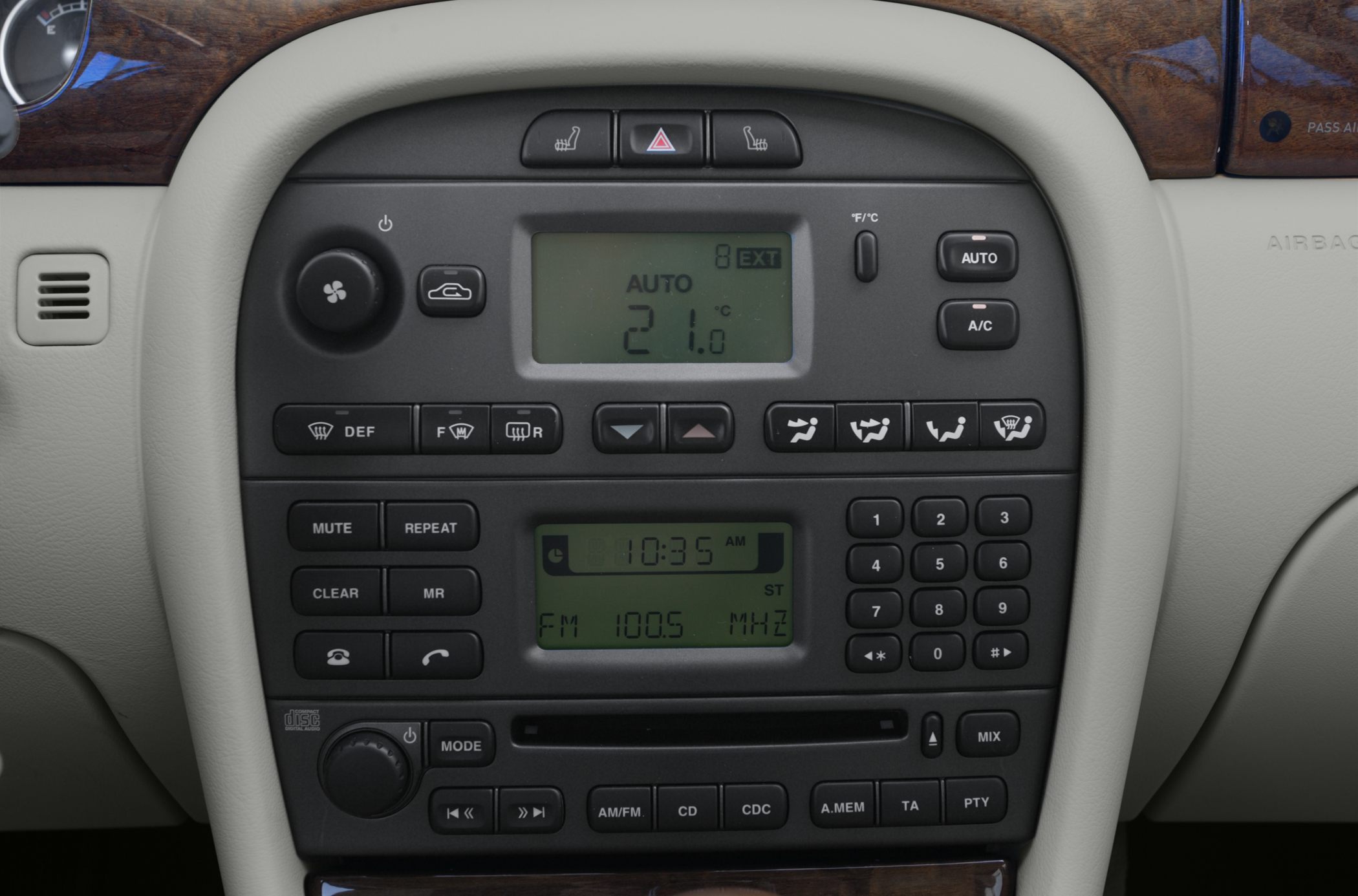 Car climate control and audio system panel with digital displays and buttons