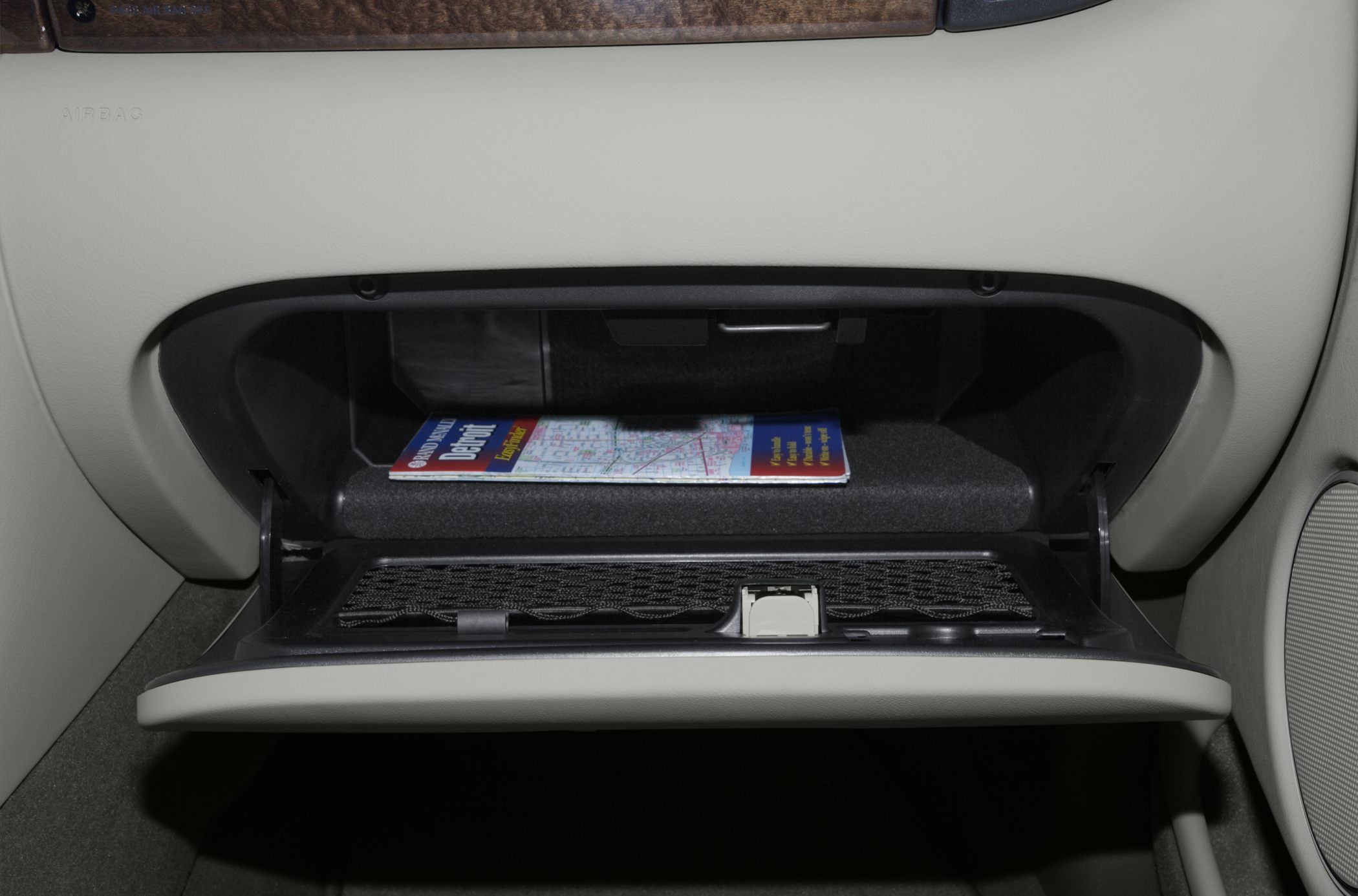 Open glove compartment with storage and a map inside
