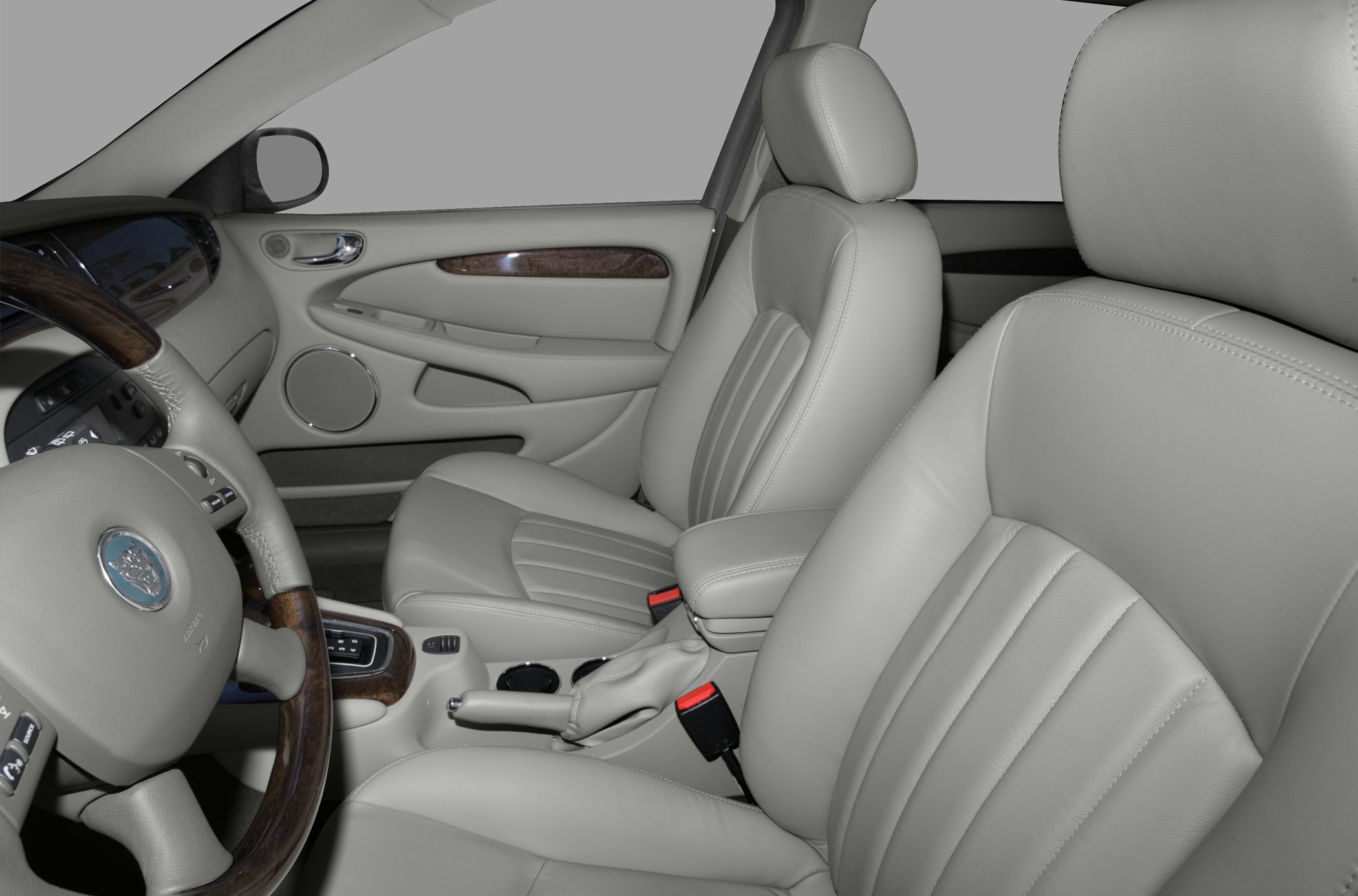 Light gray leather seats with wood trim and steering wheel