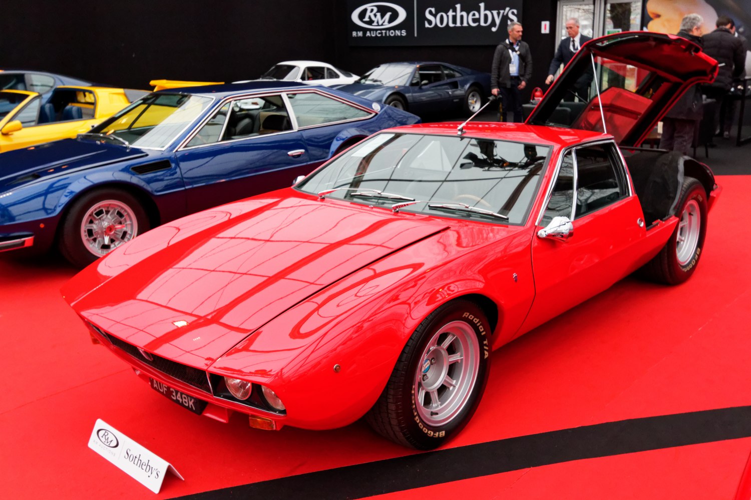 Red mid-engine hatchback with gullwing rear hatch opened
