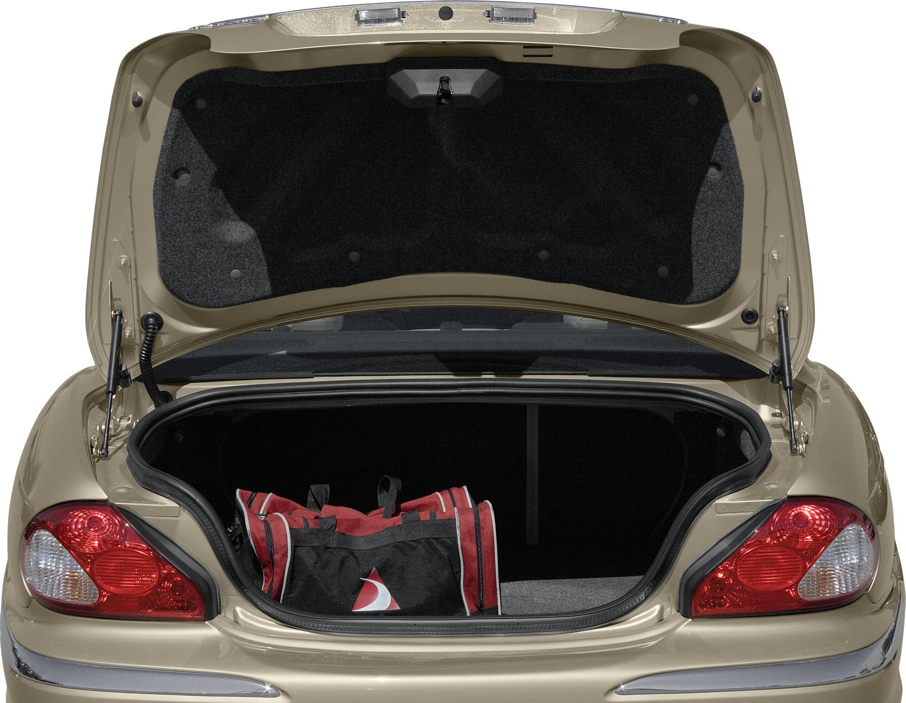 Spacious open trunk with a red and black sports bag inside.