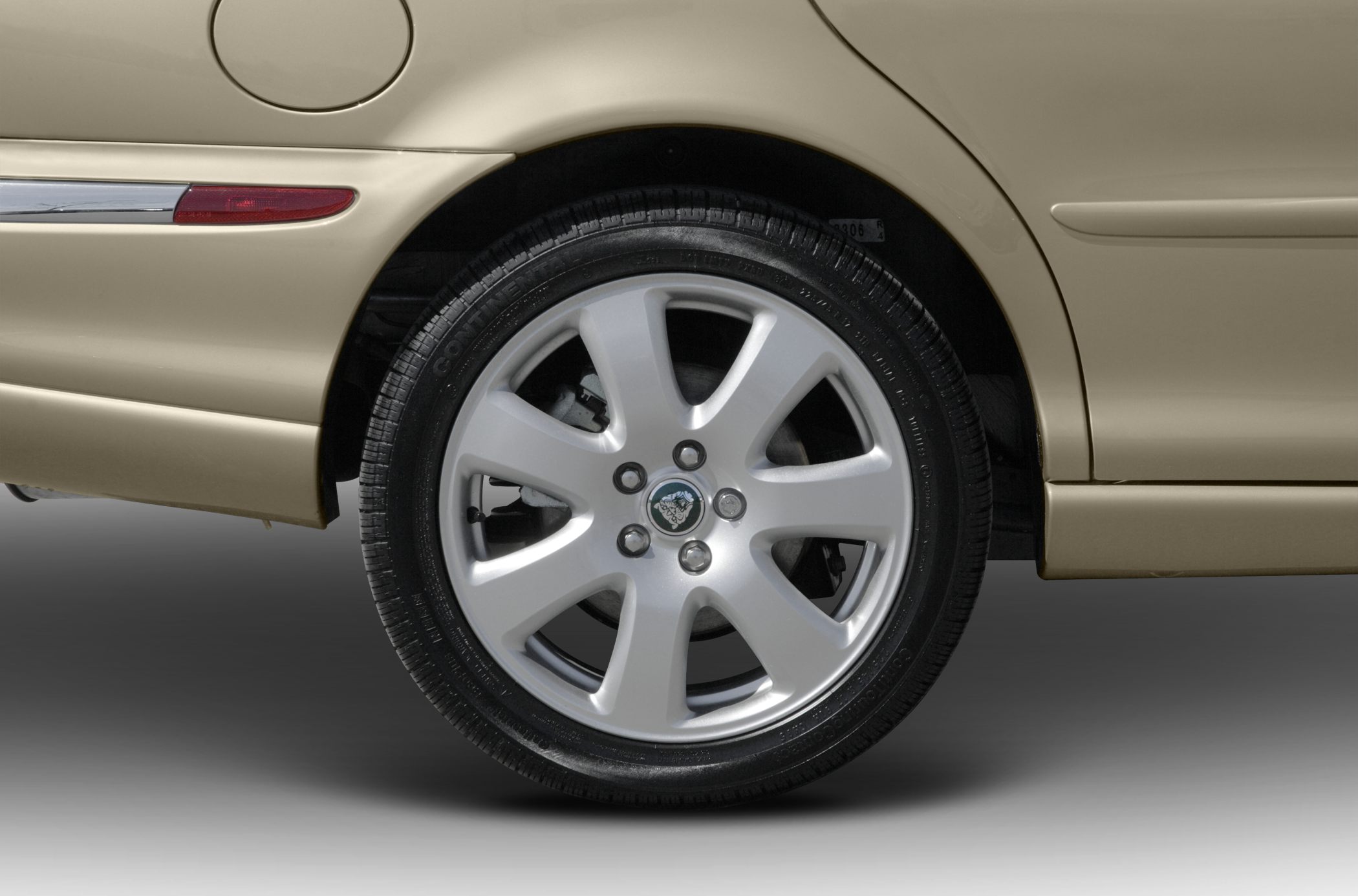 Alloy rear wheel with beige side panel and fuel door