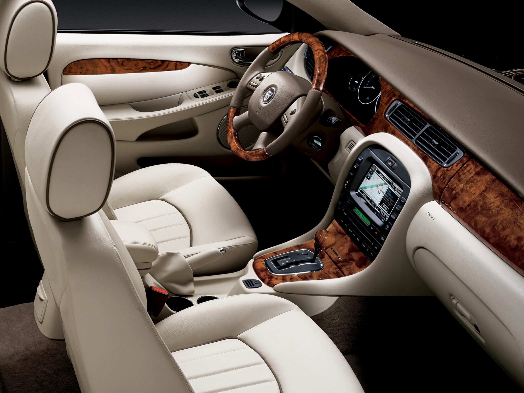 Beige leather interior with wood trim and detailed dashboard