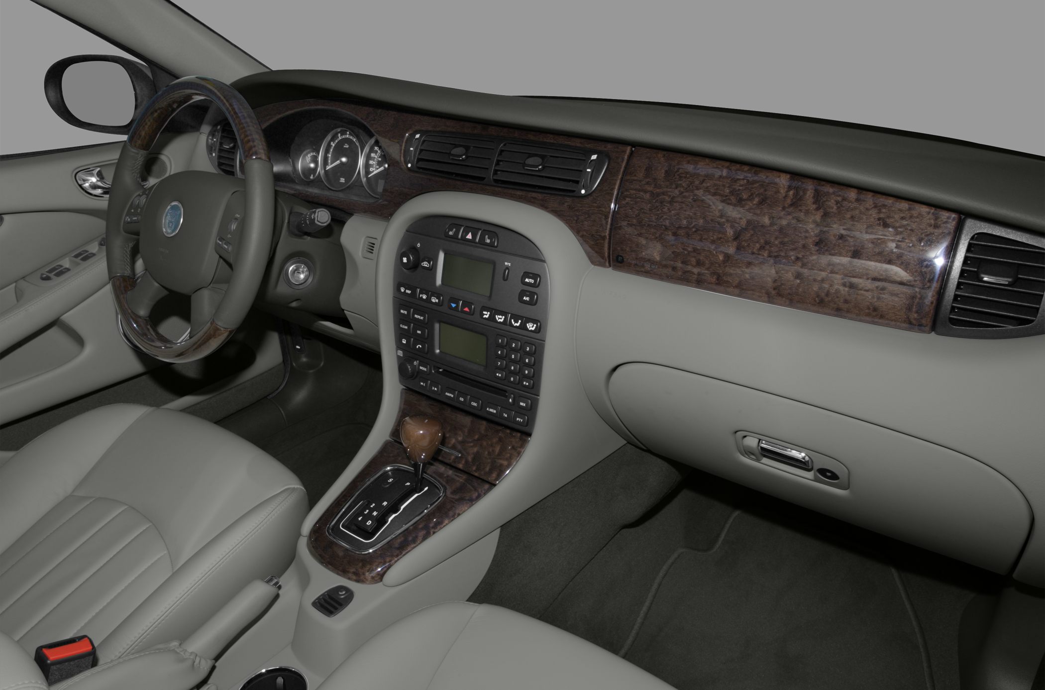 Wood trim dashboard and automatic gear shift in premium leather interior.