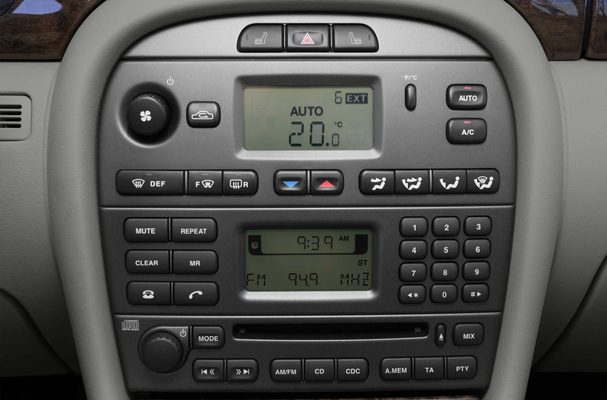 Car dashboard with climate control and radio system buttons and displays