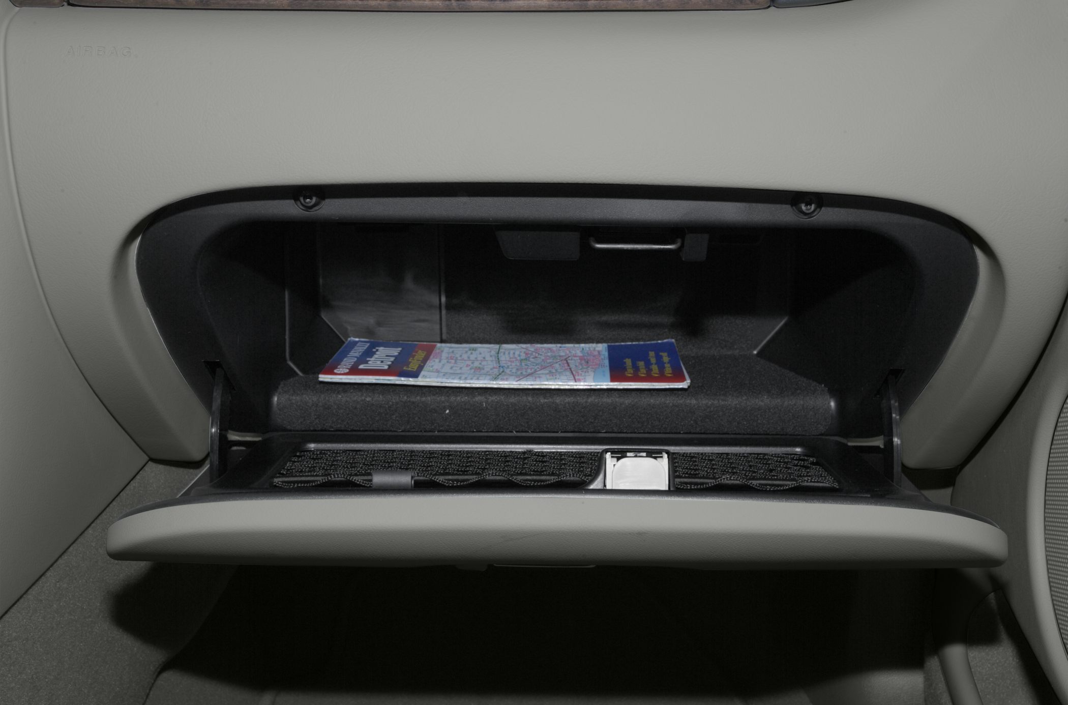 Open glove compartment with map booklet in interior