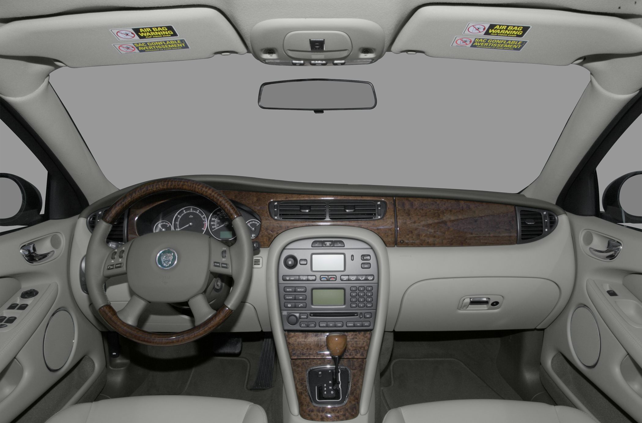 Wood-trimmed dashboard and leather steering wheel with instrument cluster and center console