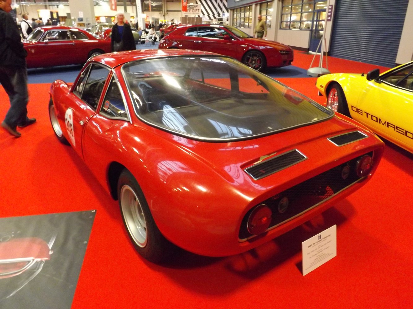 Mid-engine sports coupé with rear glass window and dual rear air vents