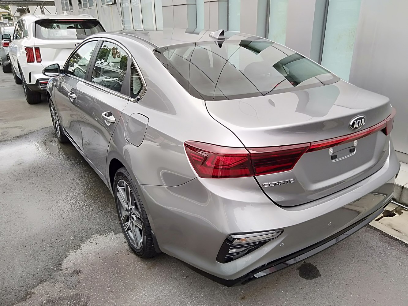 Rear view of a silver sedan with modern taillights and aerodynamic design