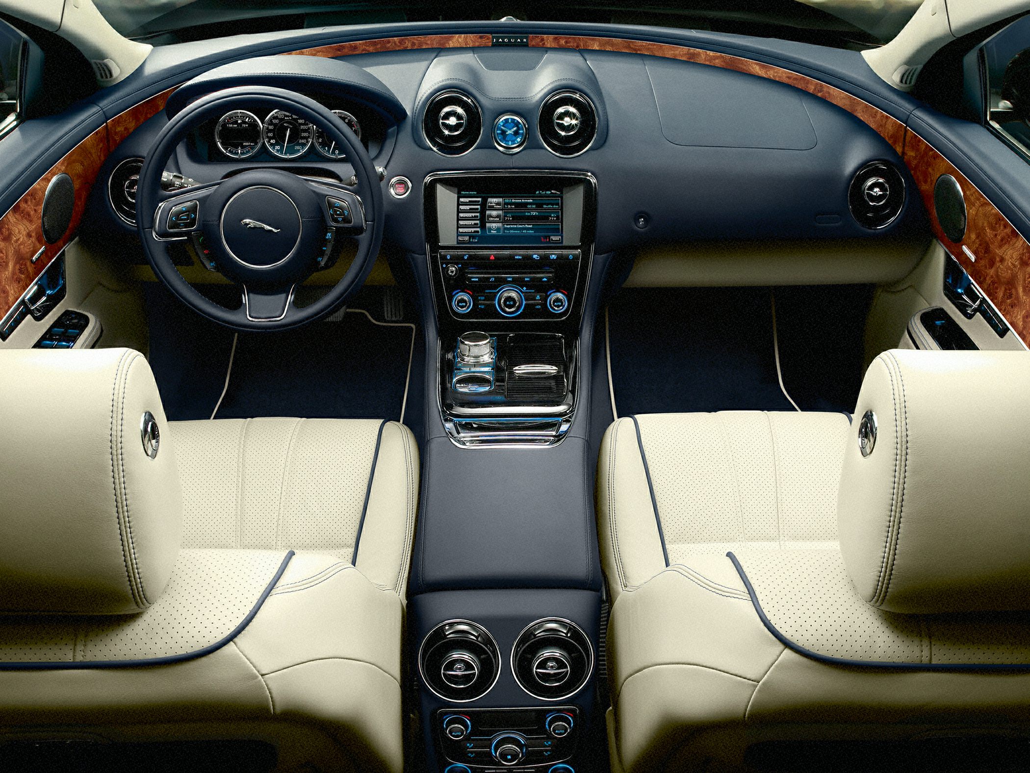 Leather seats, wood dashboard trim, digital instrument cluster, and steering wheel controls.