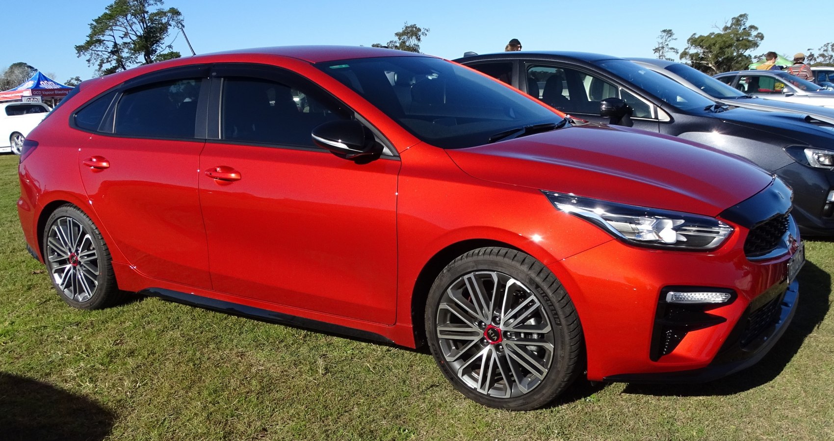 Red hatchback with LED headlights and alloy wheels