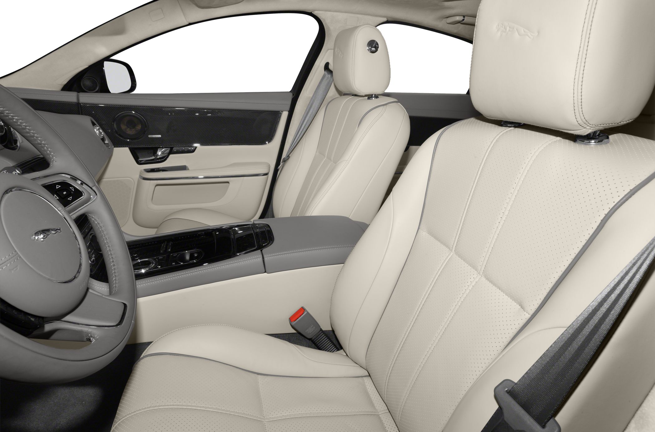Beige leather seats with carbon fiber trim and detailed stitching