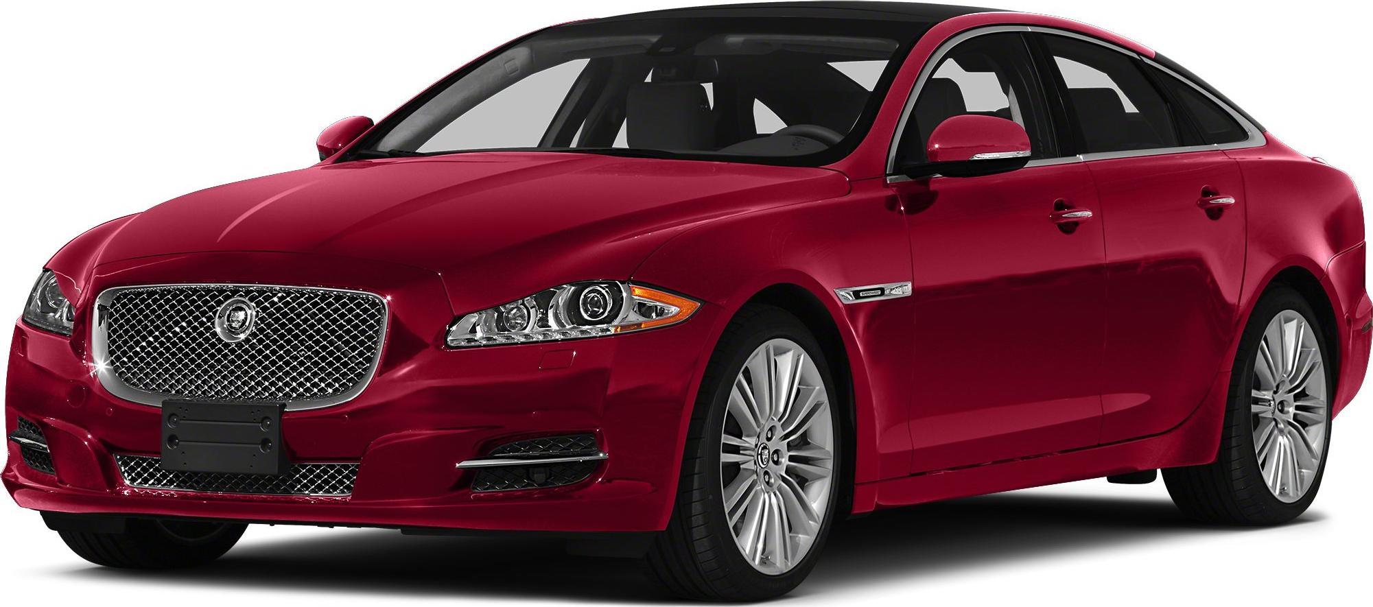 Red luxury sedan with chrome mesh grille and alloy wheels