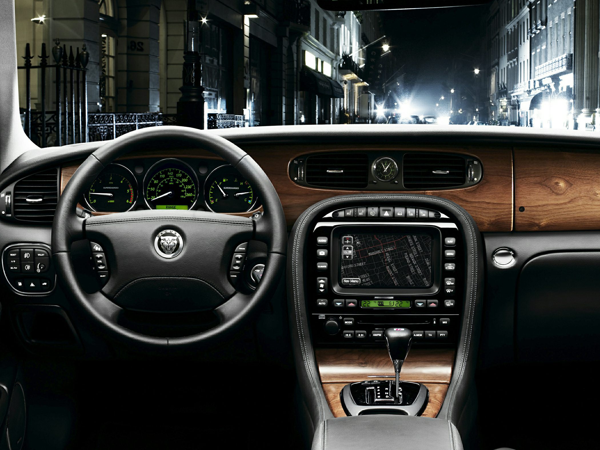 Luxury wood-trimmed dashboard with analog clock and navigation screen