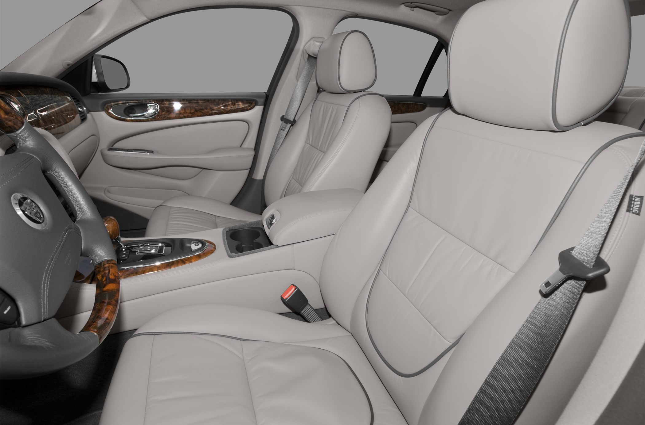 Luxury beige leather seats with wood grain trim and center console.
