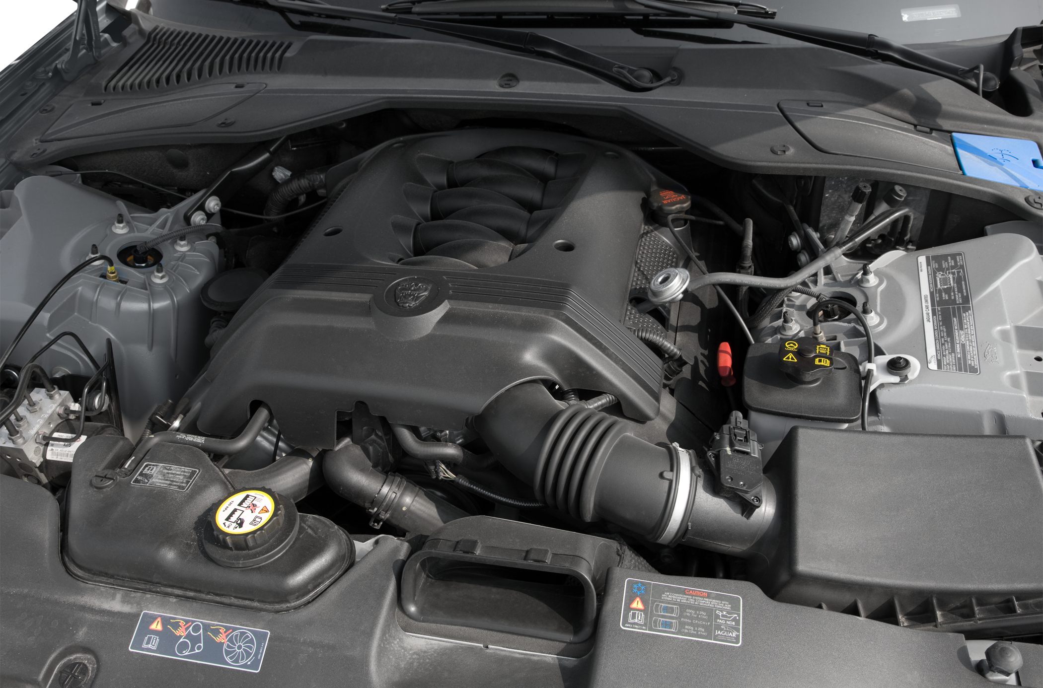 Engine compartment with intake, coolant reservoir and cover