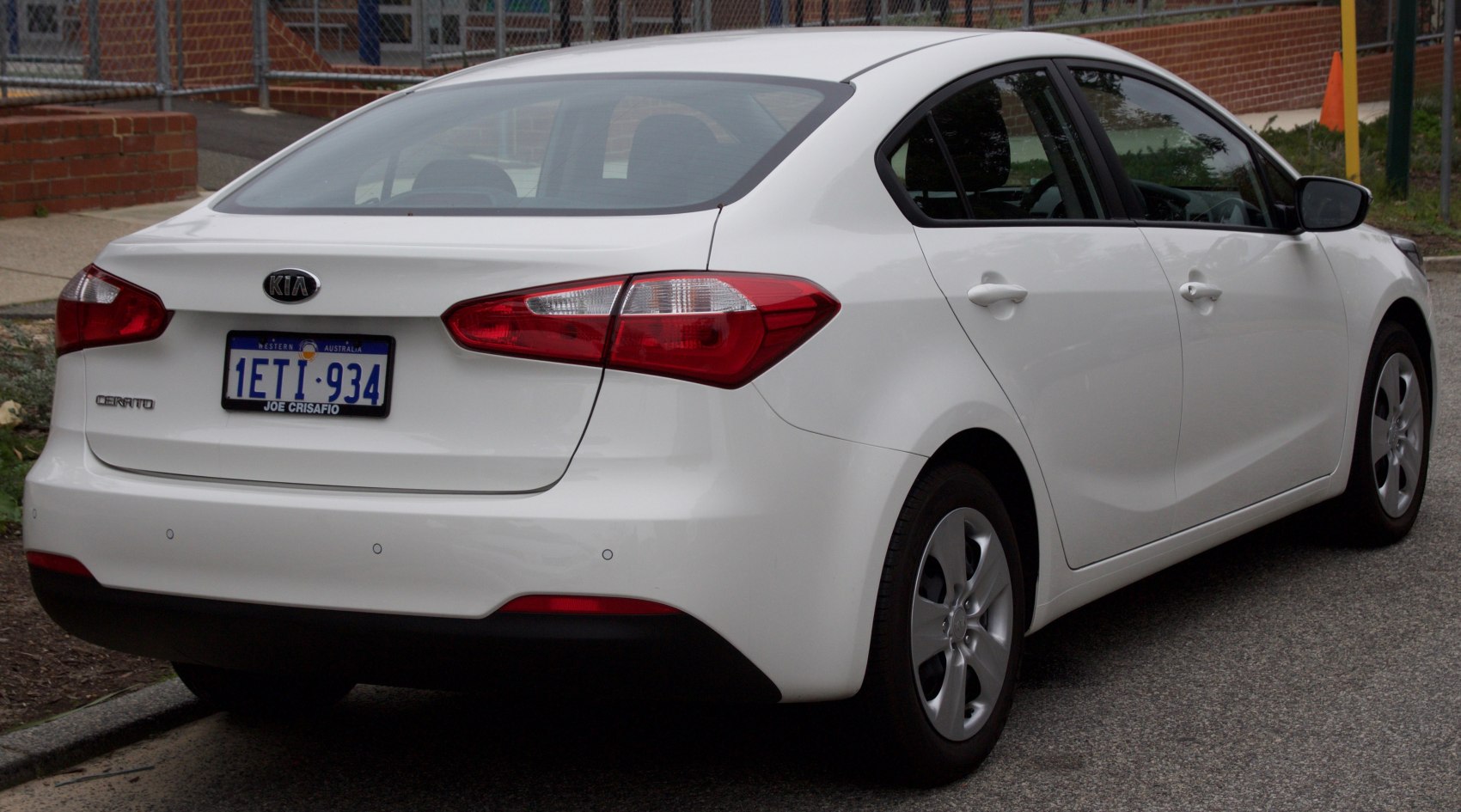 Rear view of a white sedan showcasing distinctive taillights and smooth body lines