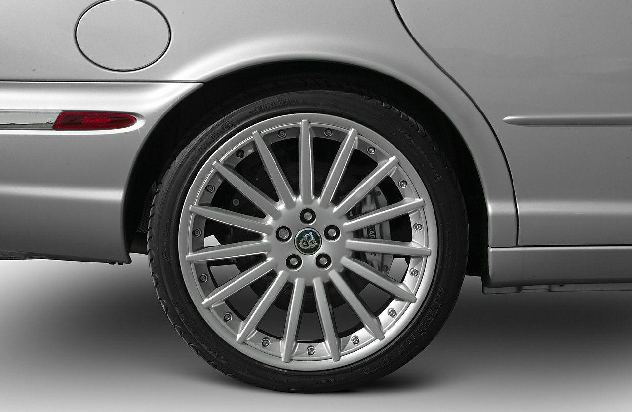 Alloy wheel with multi-spoke design and rear quarter panel of luxury sedan