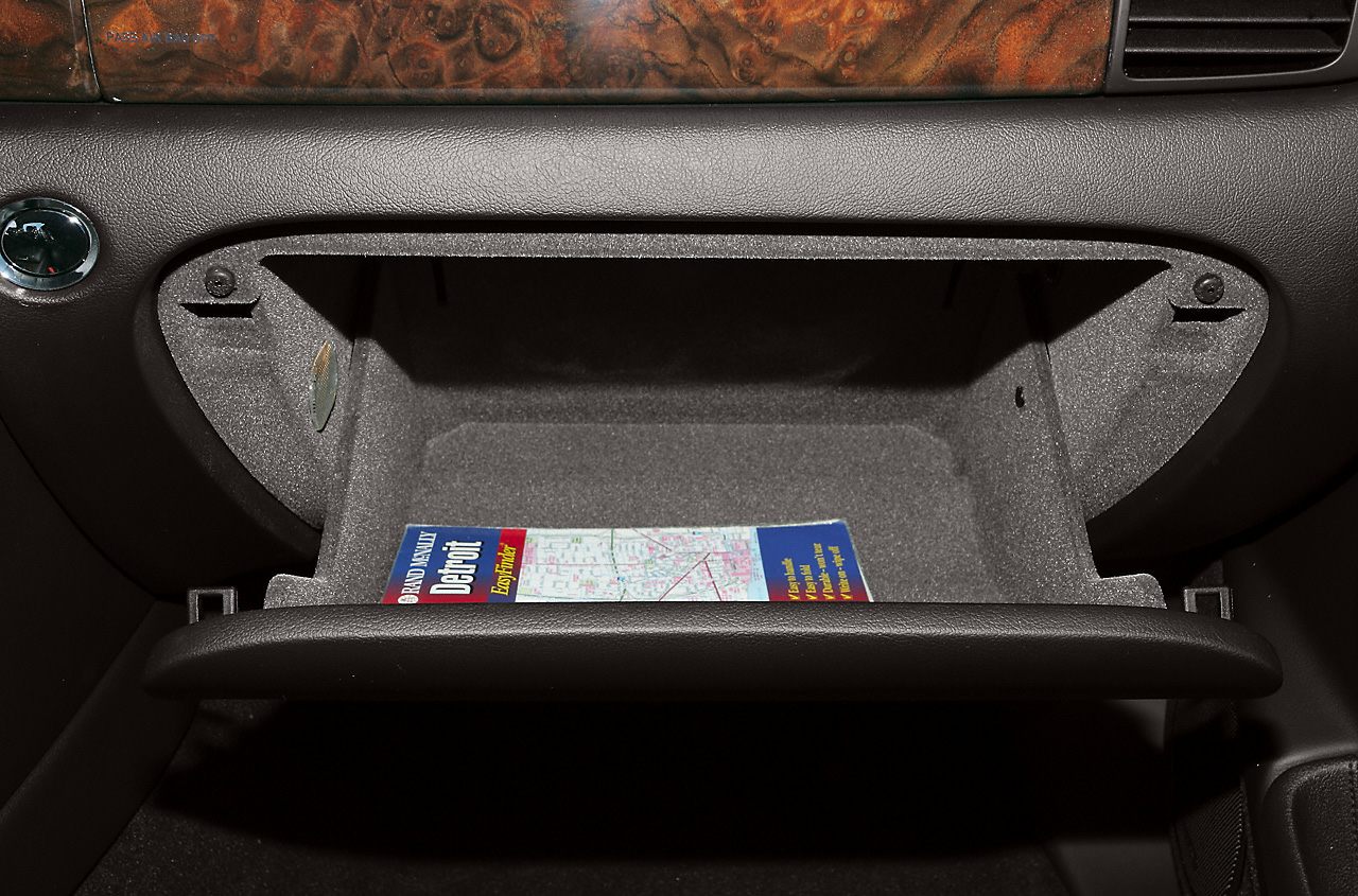 Open glove compartment with a map inside in car interior