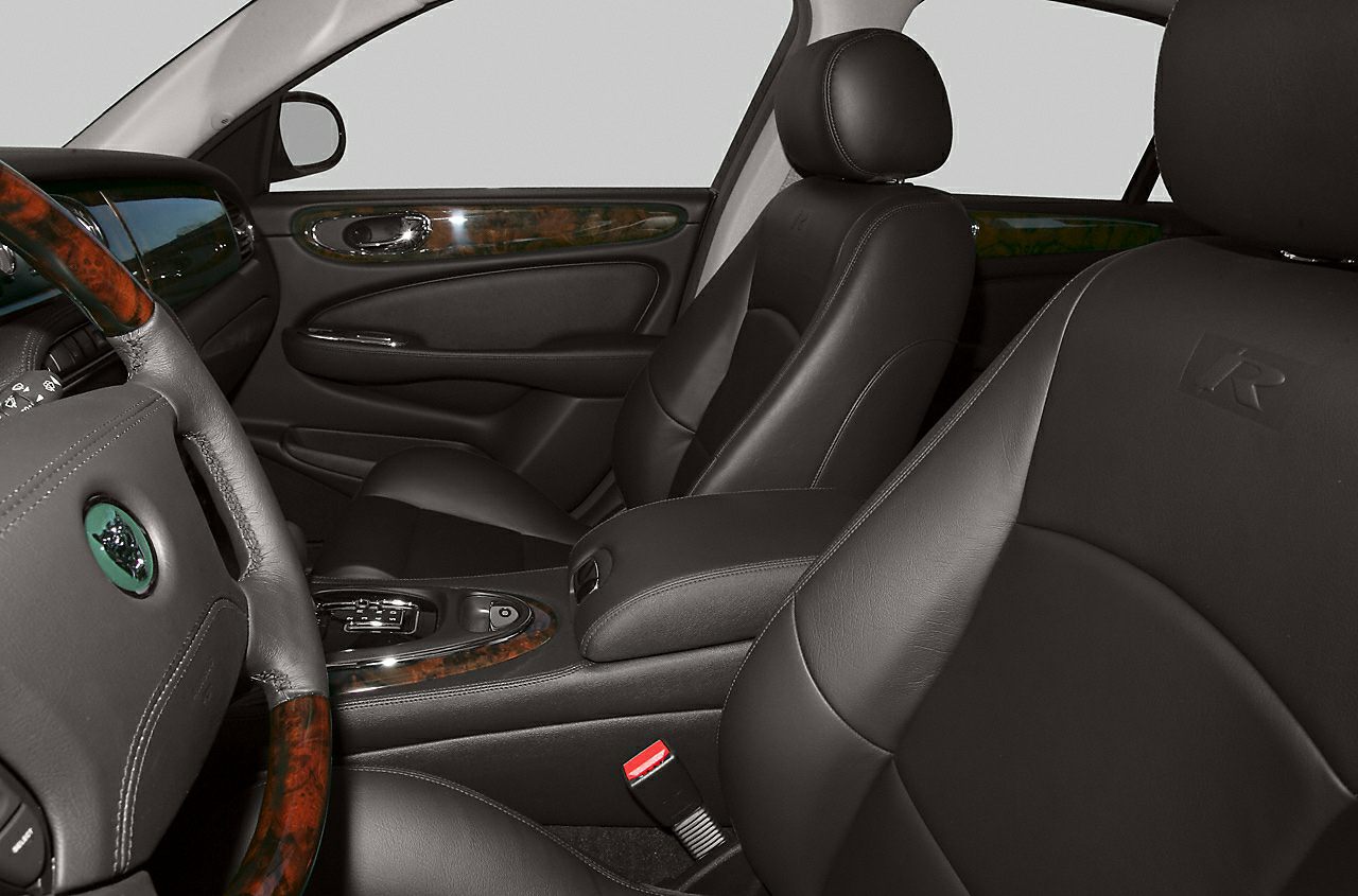 Black leather seats and wood trim in a luxury car interior