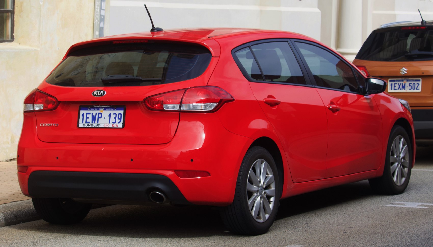 Rear view of hatchback with taillight cluster and single exhaust pipe