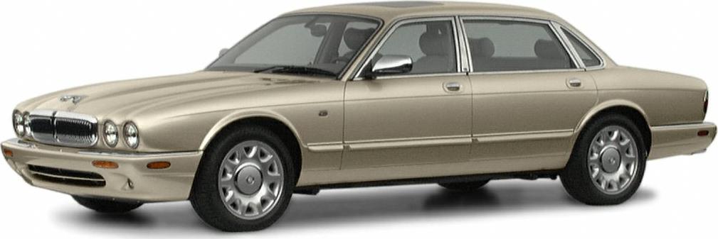 Side view of beige luxury sedan with round headlights and chrome trim