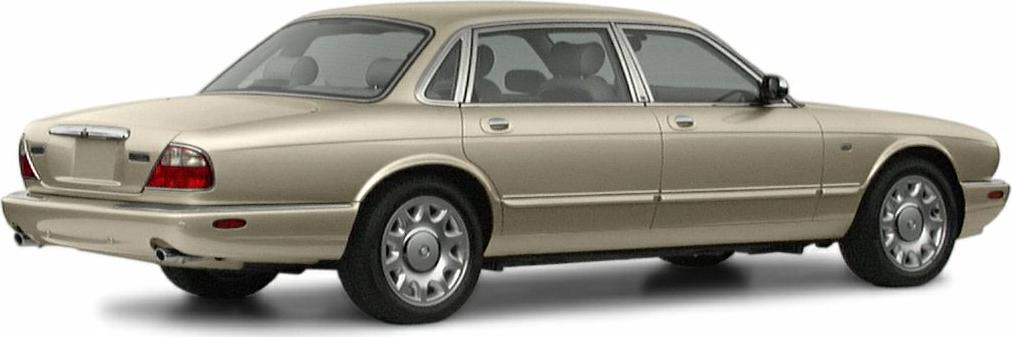 Rear side view of a beige luxury sedan with alloy wheels